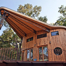 A Reclaimed Wood House Rises From the Trees
