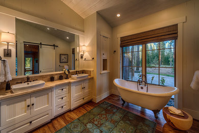 Inspiration for a rustic claw-foot bathtub remodel in San Francisco with white cabinets