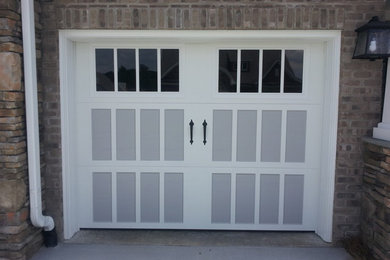 Mid-sized elegant attached two-car garage photo in Other