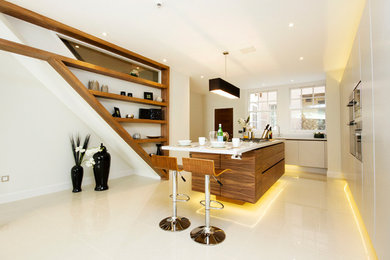 Inspiration for a contemporary kitchen in London with with island.