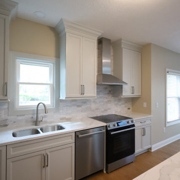 Sleek & Sophisticated: Gray Kitchen Remodel with Quartz Countertops, Marble Back