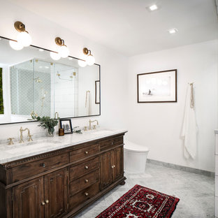 Example of a mid-sized eclectic master white tile and ceramic tile marble floor and gray floor bathroom design in San Francisco with furniture-like cabinets, brown cabinets, a bidet, white walls, an undermount sink, marble countertops and a hinged shower door