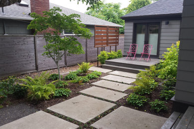 Mid-sized modern backyard shaded garden in Portland with with path and concrete pavers for summer.