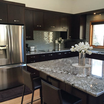 Cherry cabinets with slab doors, a custom-mixed stain, Bianco Antico granite and