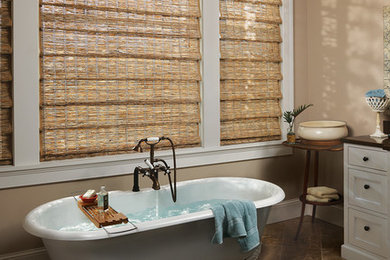 Inspiration for a large transitional master ceramic tile and brown floor freestanding bathtub remodel in Austin with beaded inset cabinets, white cabinets, beige walls, an undermount sink and solid surface countertops