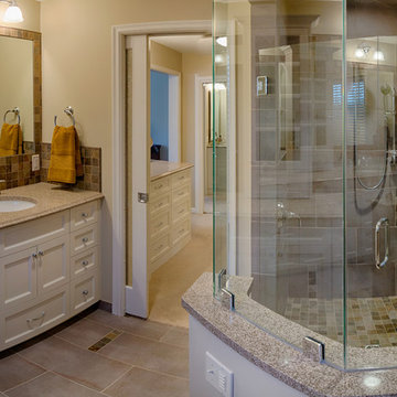 Primary Bath With Curbless Shower, Wide Bench and White Shaker Style Vanity