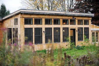 Inspiration for a rustic wood exterior home remodel in Burlington