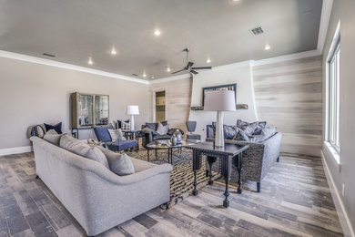 Living room - large traditional open concept porcelain tile and gray floor living room idea in Austin with gray walls, a standard fireplace, a plaster fireplace and a wall-mounted tv