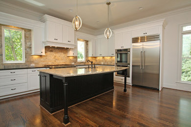 Minimalist dark wood floor kitchen photo in Atlanta with an undermount sink, shaker cabinets, white cabinets, granite countertops, brown backsplash, stone tile backsplash, colored appliances and an island