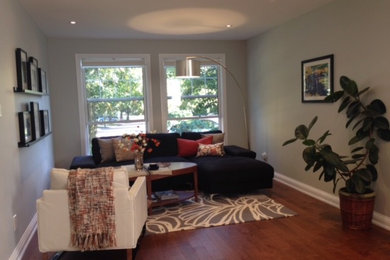 Living room - contemporary open concept medium tone wood floor living room idea in Toronto with gray walls