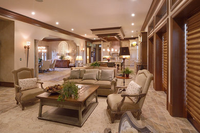 Mid-sized elegant open concept travertine floor living room photo in Orlando with white walls, no fireplace and a media wall