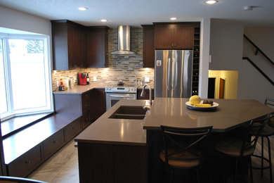 Mid-sized minimalist l-shaped ceramic tile and beige floor eat-in kitchen photo in Calgary with an undermount sink, shaker cabinets, dark wood cabinets, quartz countertops, multicolored backsplash, matchstick tile backsplash, stainless steel appliances, an island and gray countertops