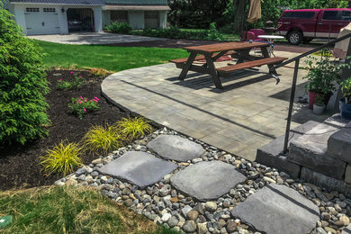 Example of a stone patio design in Philadelphia with no cover