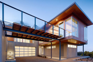 Photo of a mid-sized contemporary two-storey brown house exterior in Orange County with mixed siding and a flat roof.