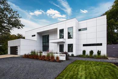 Mid-sized minimalist white two-story concrete fiberboard exterior home photo in Dallas with a metal roof