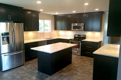 Transitional kitchen photo in Vancouver with shaker cabinets, dark wood cabinets, quartzite countertops and an island