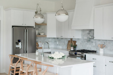 Large trendy l-shaped light wood floor, multicolored floor and vaulted ceiling kitchen pantry photo in Los Angeles with an undermount sink, recessed-panel cabinets, white cabinets, quartz countertops, blue backsplash, ceramic backsplash, stainless steel appliances, an island and white countertops