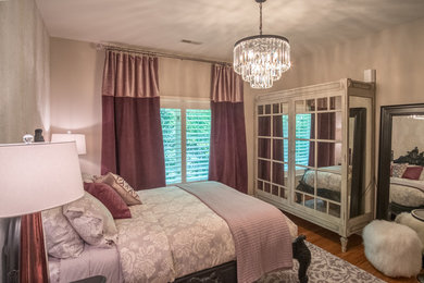 Inspiration for a mid-sized transitional guest medium tone wood floor bedroom remodel in Other with beige walls and no fireplace