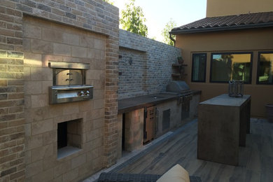 Inspiration for a large timeless backyard concrete paver and custom-shaped natural pool house remodel in Los Angeles
