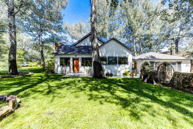 Example of a mid-sized mountain style white one-story wood exterior home design in Denver with a shingle roof