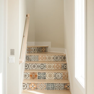 This is an example of a large nautical wood curved wood railing staircase in Other with tiled risers.