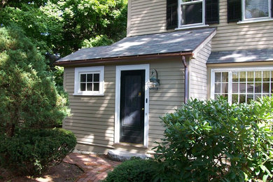 Example of a mid-sized classic gray two-story vinyl gable roof design in Boston