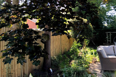 Inspiration for a medium sized rural back partial sun garden for summer in Hampshire with natural stone paving.