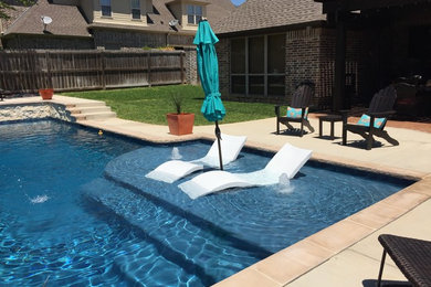 Example of a mid-sized classic backyard concrete and rectangular lap pool fountain design in Austin