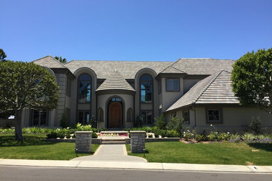 Expansive transitional two-storey stucco beige exterior in Orange County.