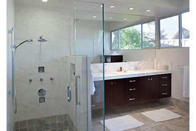 Design ideas for a mid-sized transitional master bathroom in Other with a corner shower, gray tile, white walls, flat-panel cabinets, dark wood cabinets, a two-piece toilet, marble, an undermount sink, engineered quartz benchtops, grey floor, a hinged shower door and porcelain floors.