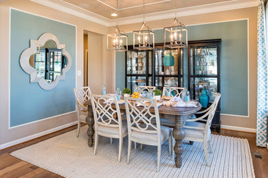 Photo of a country dining room in Baltimore with blue walls and medium hardwood floors.