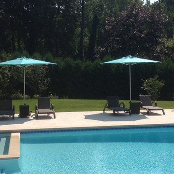 Poolside Wicker Lounge Chairs and Market Umbrella