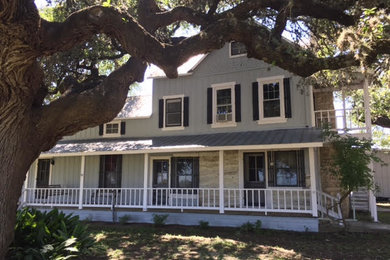 Inspiration for a mid-sized timeless blue three-story wood exterior home remodel in Other with a metal roof