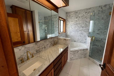 Bathroom - 1960s white tile and marble tile marble floor, white floor and single-sink bathroom idea in Los Angeles with flat-panel cabinets, brown cabinets, a one-piece toilet, white walls, an undermount sink, marble countertops, white countertops and a built-in vanity