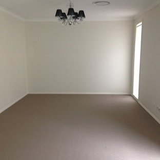 Mid-sized minimalist enclosed ceramic floor home theater photo in Newcastle - Maitland with white walls and a wall-mounted tv
