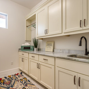 Design ideas for a medium sized classic single-wall separated utility room in Tampa with a submerged sink, recessed-panel cabinets, white cabinets, onyx worktops, white walls and porcelain flooring.