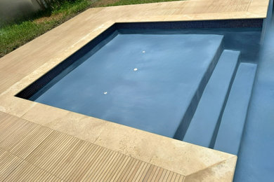 Large minimalist backyard rectangular pool photo in Miami