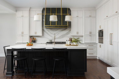 Example of a huge transitional l-shaped medium tone wood floor kitchen design in Chicago with an undermount sink, beaded inset cabinets, white cabinets, quartz countertops, gray backsplash, quartz backsplash, paneled appliances, two islands and white countertops