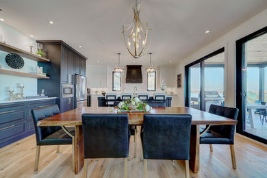 Huge trendy medium tone wood floor kitchen/dining room combo photo in Montreal