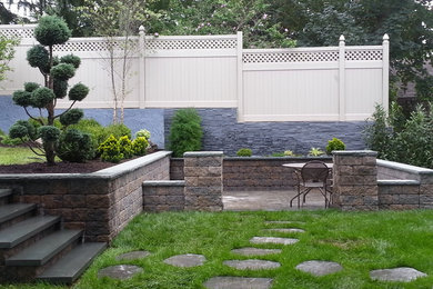 Example of a mid-sized transitional backyard brick patio design in New York with no cover