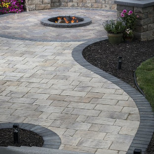 Mid-sized traditional backyard partial sun formal garden in New York with a fire feature and natural stone pavers for summer.