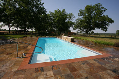 Design ideas for a large traditional backyard rectangular lap pool in Other with tile.