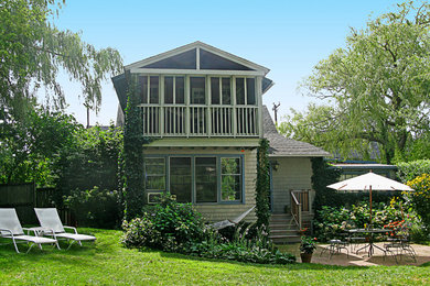 Mid-sized mountain style gray two-story wood exterior home photo in New York with a hip roof