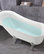 Freestanding claw foot white acrylic bathtub with polished chrome pop-up drain
