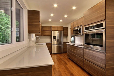 Eat-in kitchen - contemporary bamboo floor and brown floor eat-in kitchen idea in Toronto with a double-bowl sink, flat-panel cabinets, dark wood cabinets, quartz countertops and stainless steel appliances