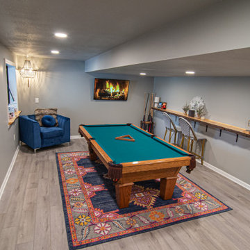Basement Utilizing Open Space to Shoot Pool and Watch Favorite Sports Team