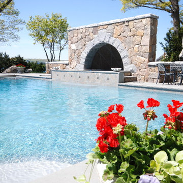 Pool with granite arch and half dome over spa