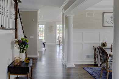 Dark wood floor and brown floor foyer photo in Chicago with gray walls