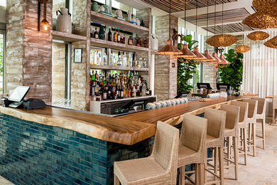 Photo of a large contemporary home bar in Miami.