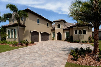 Tuscan beige two-story stucco exterior home photo in Orlando